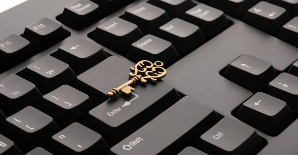 Close-up of an ornate vintage key placed on a modern computer keyboard.