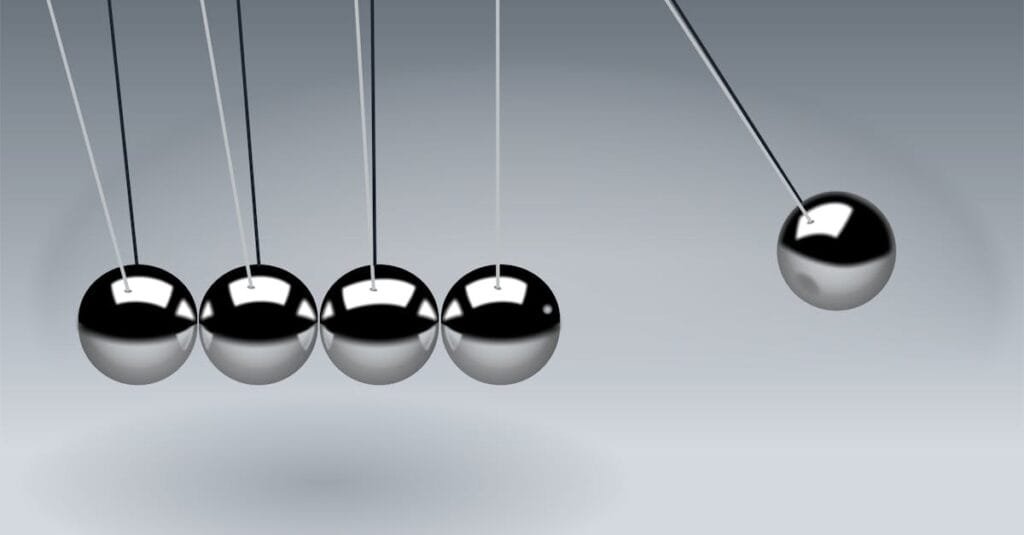 Dynamic illustration of Newton's Cradle showing motion and reflection concepts in physics.