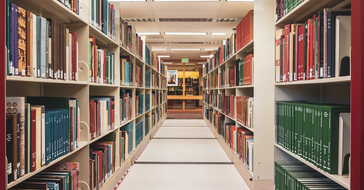 Long aisle in a library with shelves full of various colorful books, perfect for education and research.