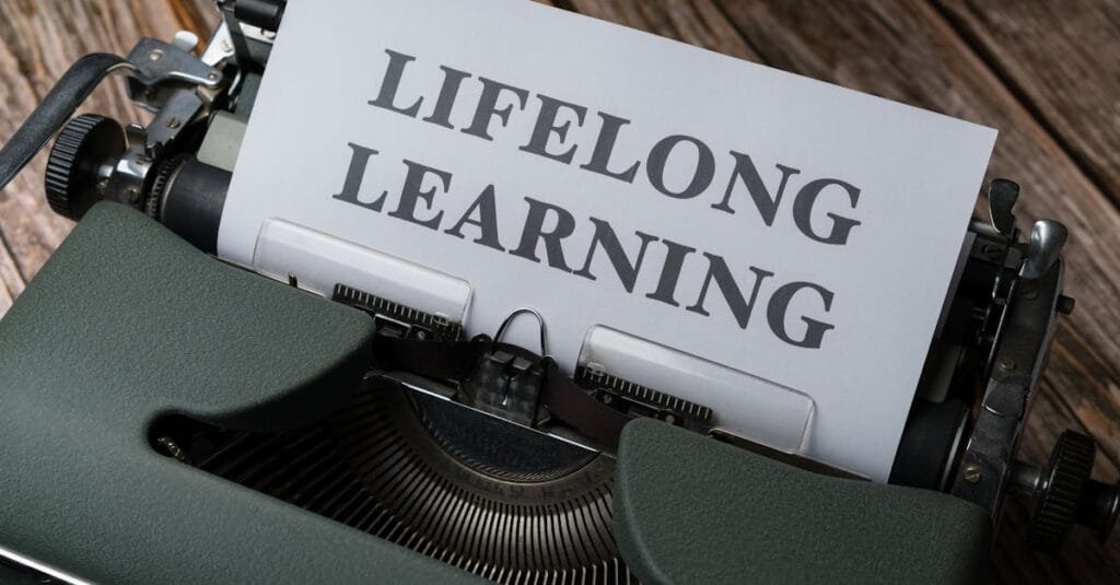 A classic typewriter displaying 'Lifelong Learning' on paper, symbolizing ongoing education.