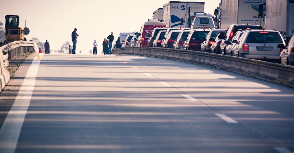 A congested highway with cars and trucks in a traffic jam during daylight.