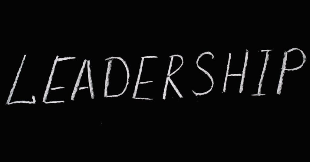Chalk text spelling 'Leadership' on a blackboard, symbolizing guidance and authority.