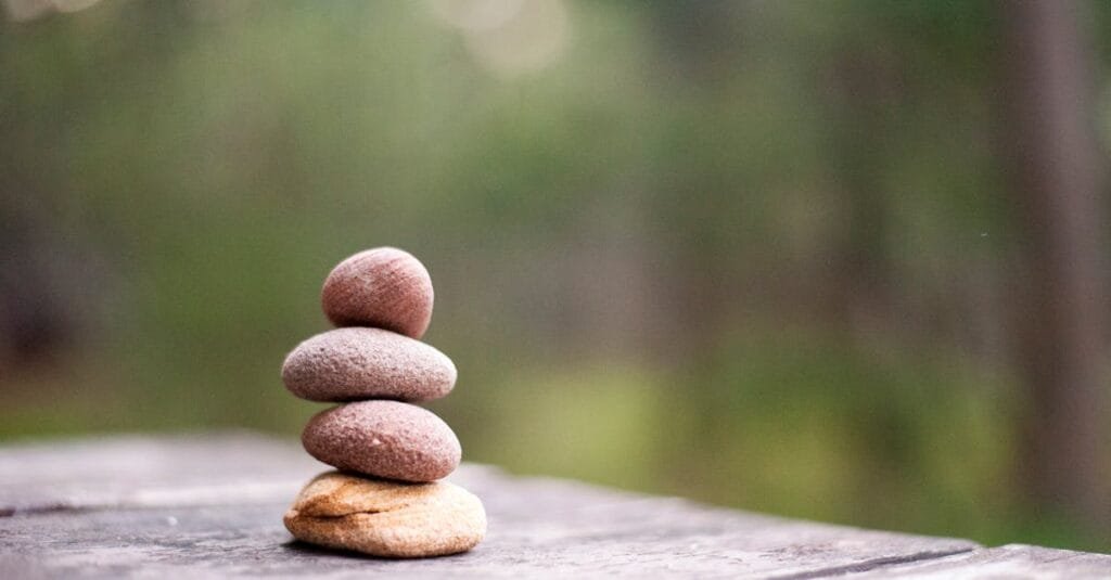 Balance and tranquility embodied by stacked stones in a natural outdoor setting.