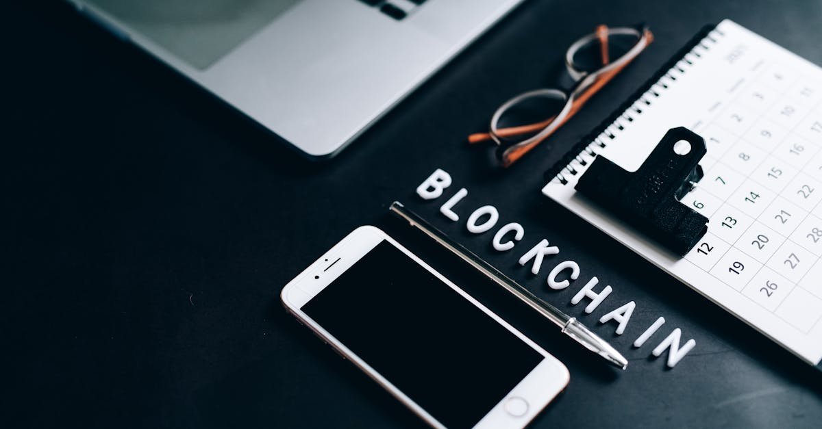Flat lay of a modern digital workspace with blockchain theme, featuring a smartphone and calendar.