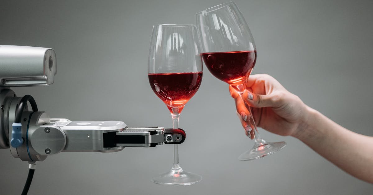 A robot and a human hand clinking glasses of red wine, symbolizing technology and celebration.