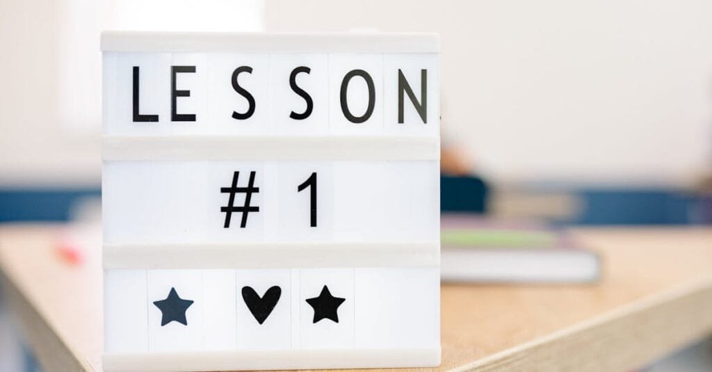 Lightbox sign displaying 'Lesson #1' in a classroom setting, symbolizing education and new beginnings.