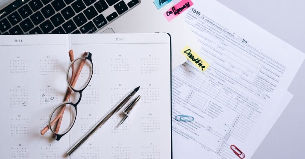 Organized workspace featuring a calendar, tax documents, and planner essentials.