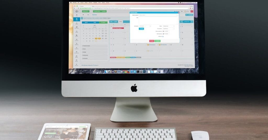 A sleek office setup featuring an Apple iMac, iPad, and keyboard on a wooden desk.