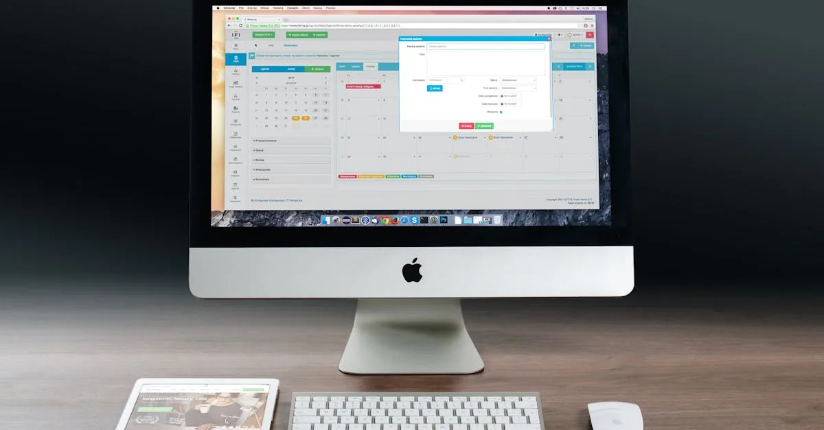 A sleek office setup featuring an Apple iMac, iPad, and keyboard on a wooden desk.