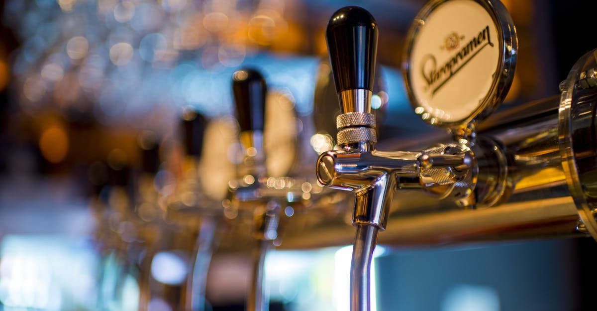 Focused image of a shiny beer tap in a stylish bar with a blurred background.