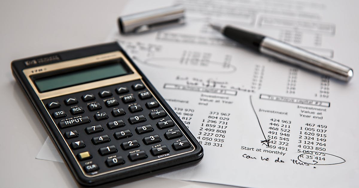 Close-up of financial documents with calculator and pen, ideal for business management themes.