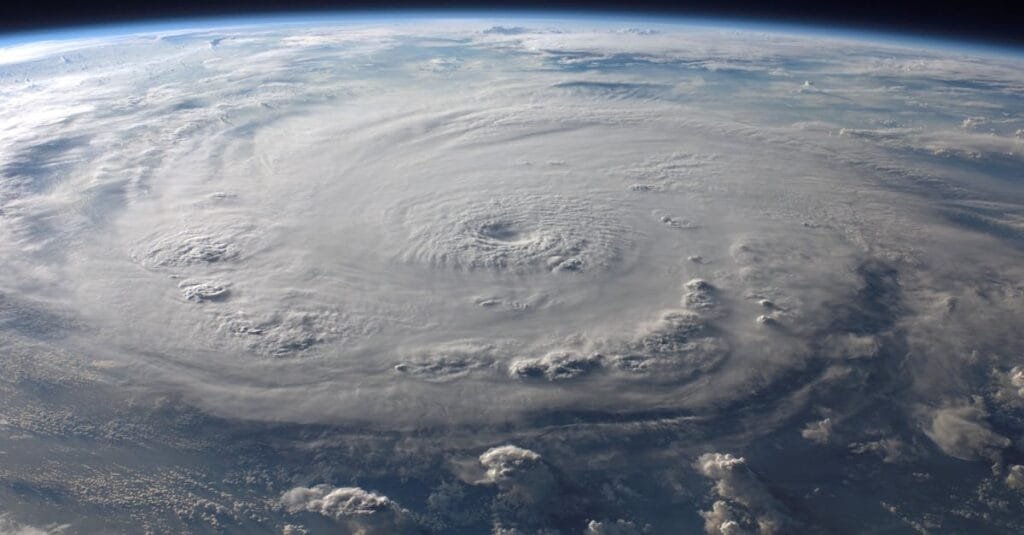 A stunning aerial view of Earth with a massive swirling hurricane, highlighting meteorological beauty.