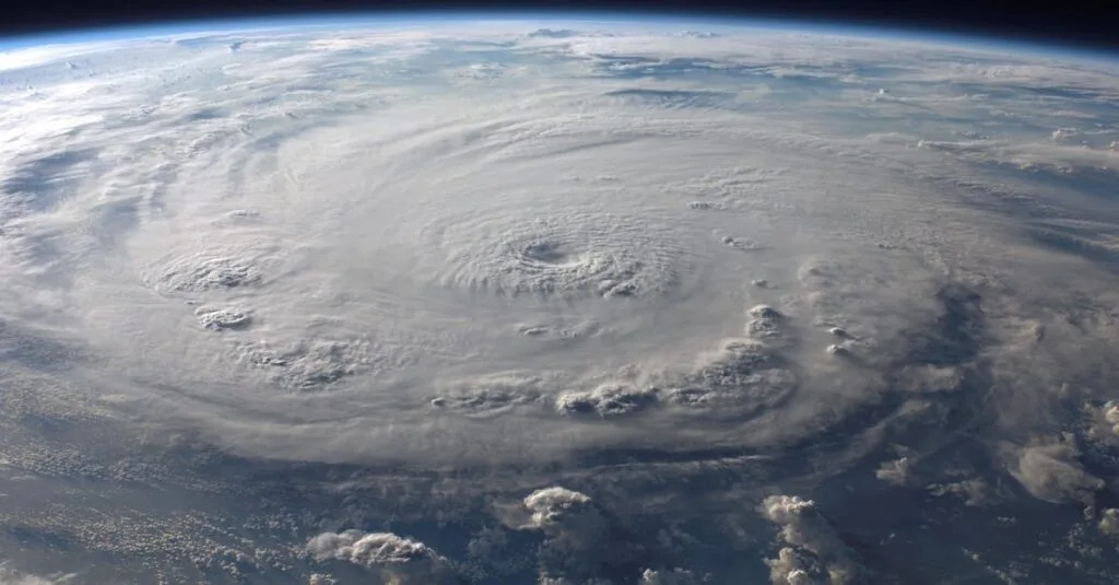 A stunning aerial view of Earth with a massive swirling hurricane, highlighting meteorological beauty.