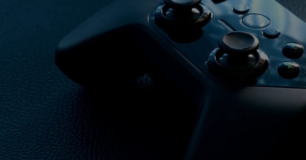 A detailed macro shot of a black game controller with reflections, emphasizing technology and gaming.