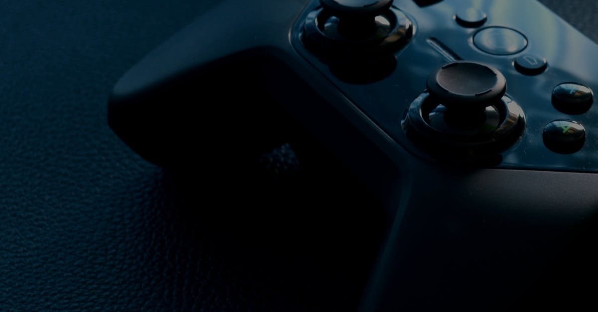 A detailed macro shot of a black game controller with reflections, emphasizing technology and gaming.