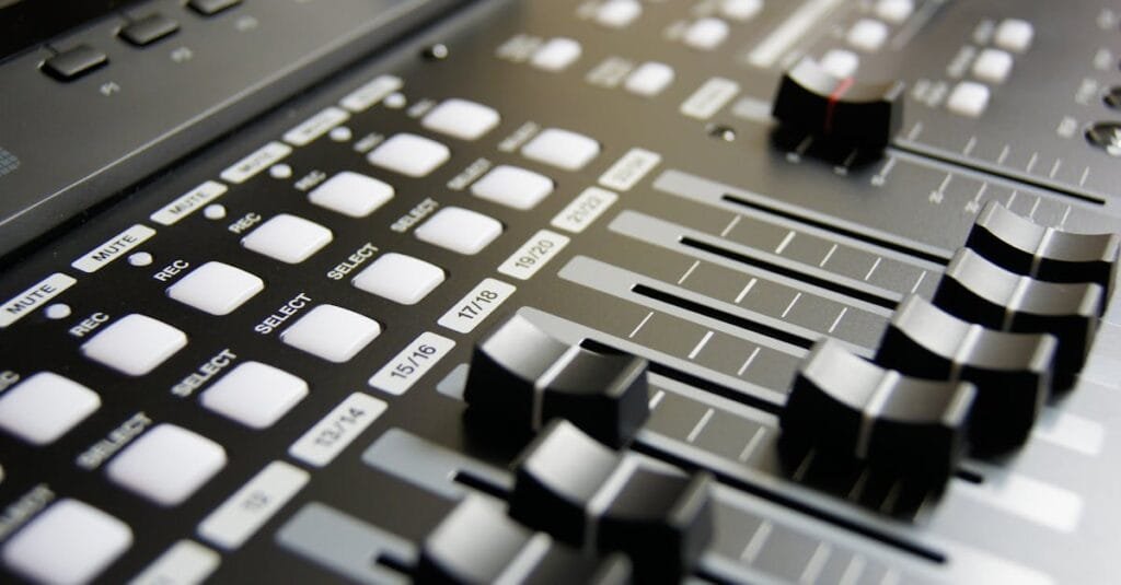 Detailed view of audio mixer sliders and buttons for sound engineering and music production.