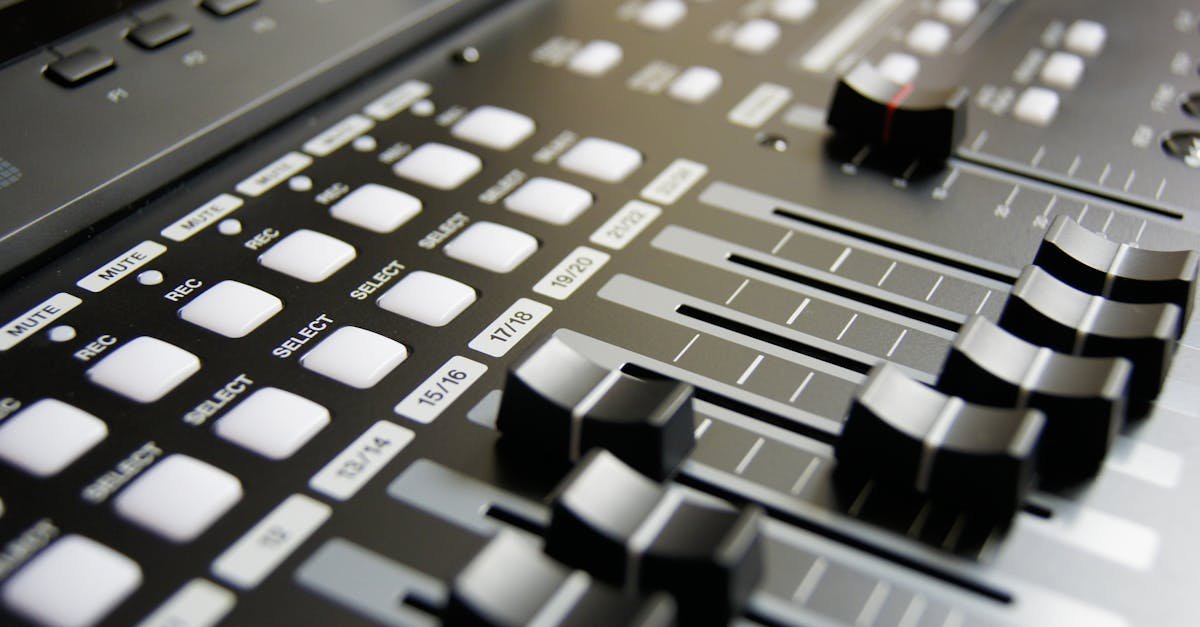 Detailed view of audio mixer sliders and buttons for sound engineering and music production.