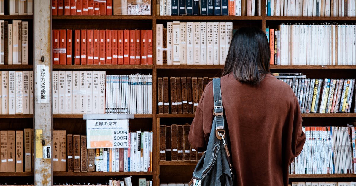 Woman browsing books at a library in Nagano, Japan. Explore knowledge and literature.