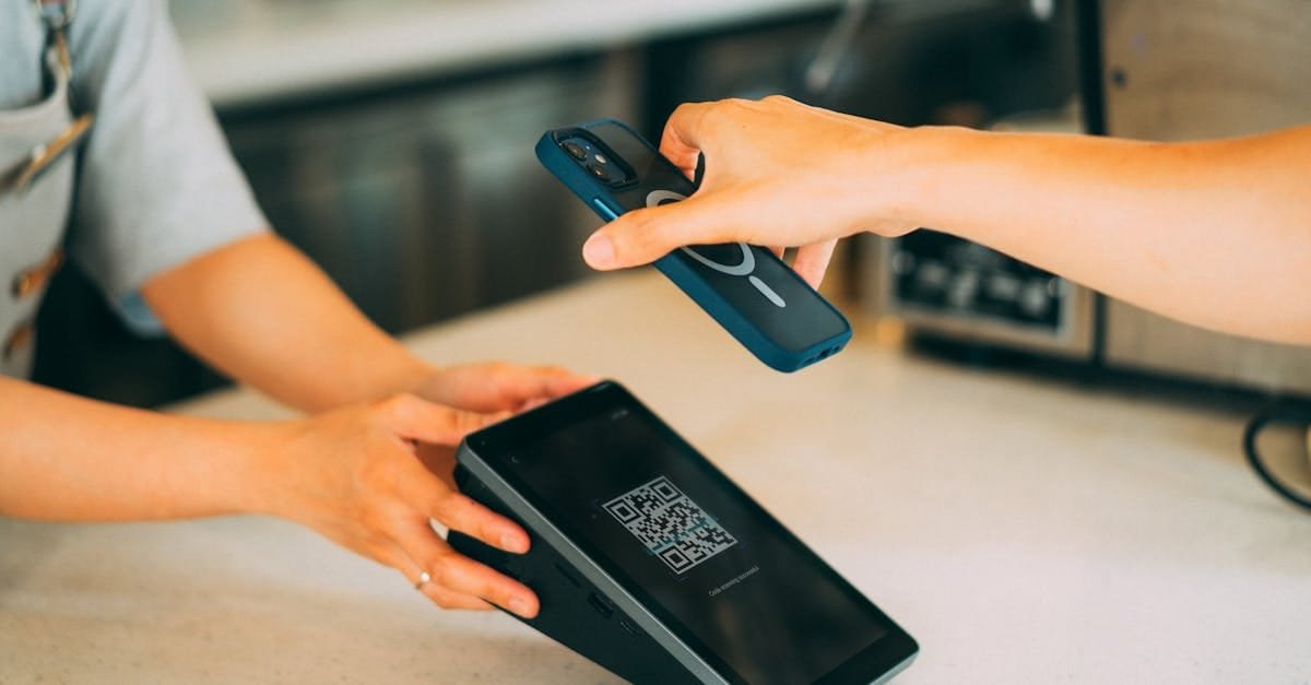 Close-up of a contactless payment using a smartphone and QR code scanner in a modern retail setting.