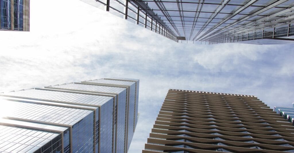 Low-angle view of high-rise buildings against a bright blue sky in Austin, Texas.