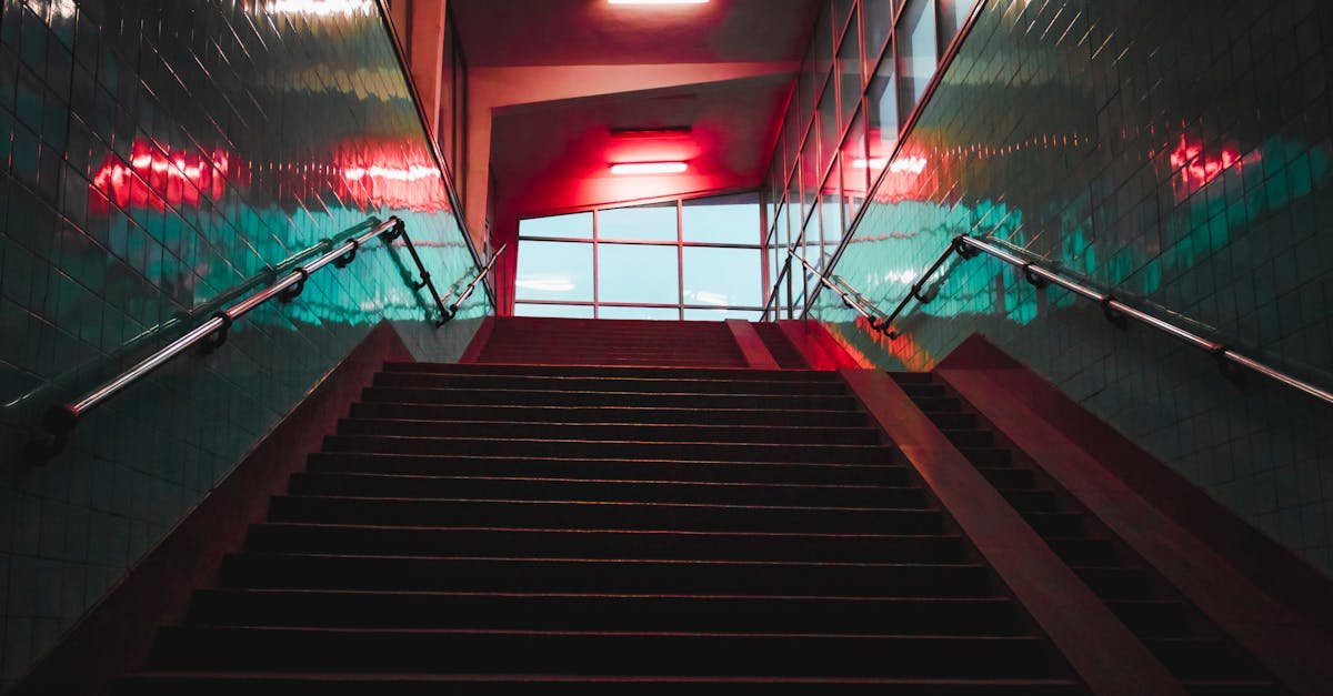 A striking view of an illuminated staircase in an urban setting with neon lighting.