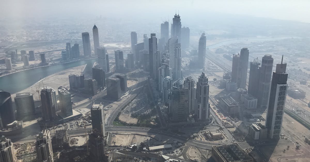 Stunning aerial view of Dubai's skyscrapers and modern architecture under a hazy sky.