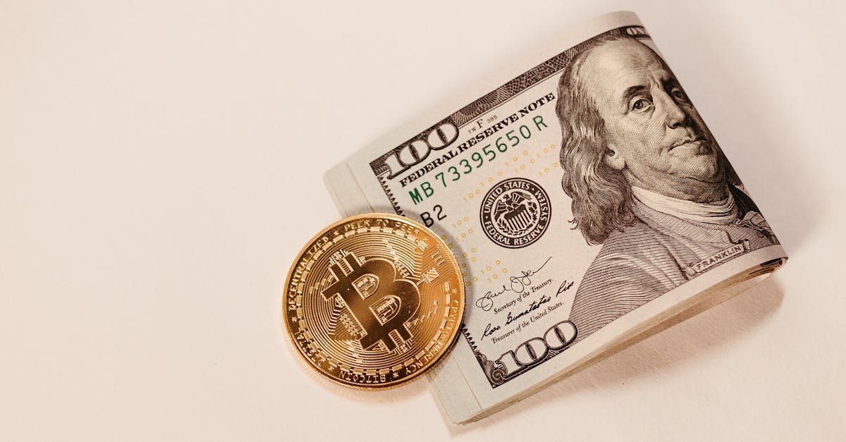 A Bitcoin coin placed next to a rolled US hundred dollar bill, symbolizing cryptocurrency and traditional currency.