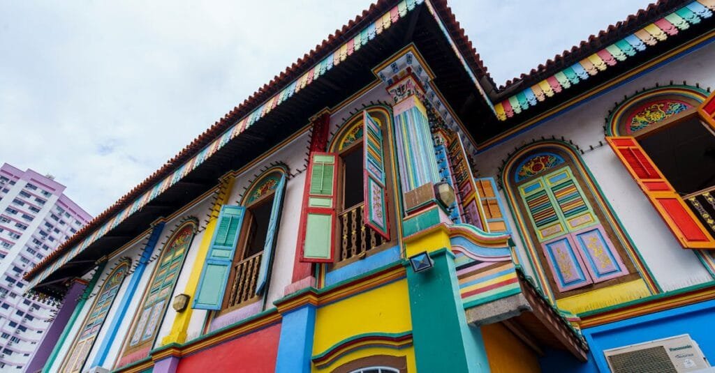 Colorful traditional house in Singapore's Little India, showcasing vibrant architecture with ornate window shutters.