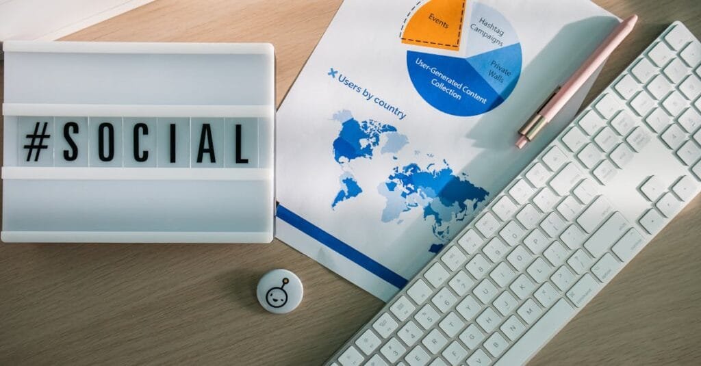 Top view of a desk with social media hashtag, keyboard, and analytics chart in modern design.