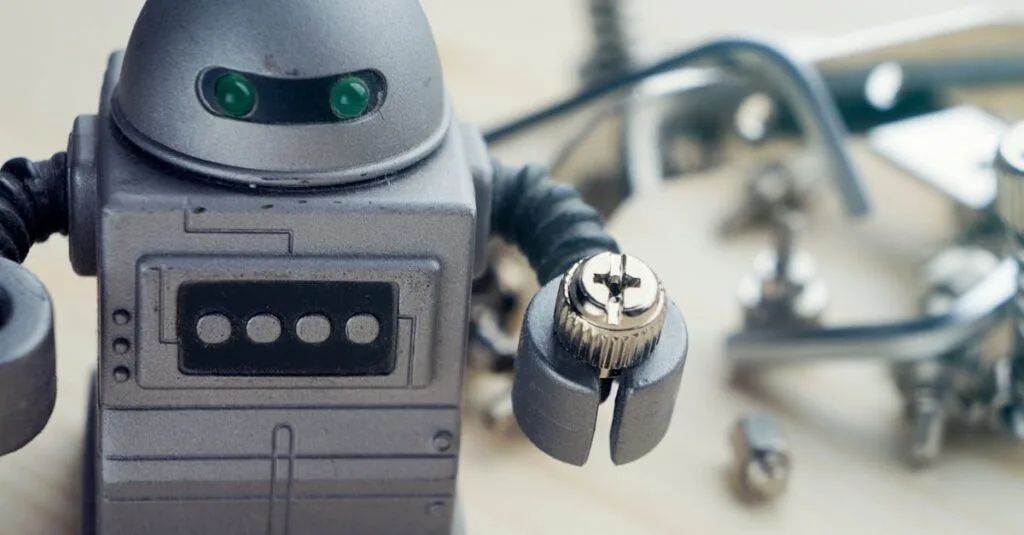 Detailed view of a toy robot holding a metallic screw, surrounded by tools.
