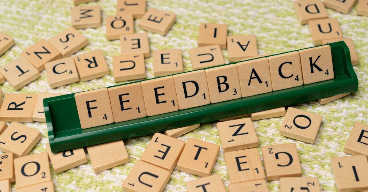 Wooden letter tiles spelling 'feedback' on a green rack, representing communication and evaluation.