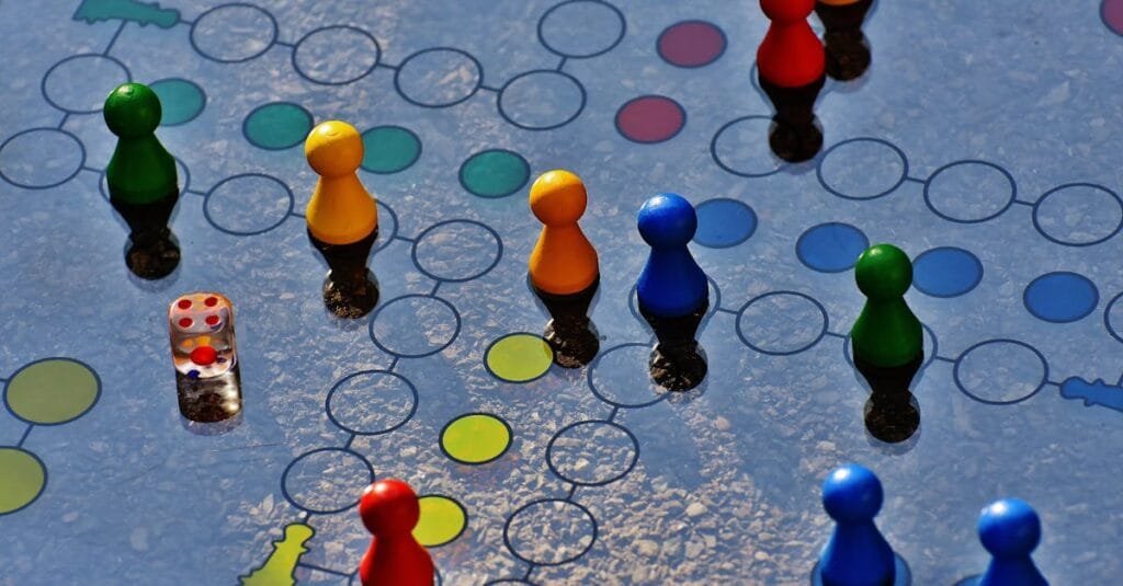 Close-up of a colorful board game with pawns and a dice, perfect for family fun.