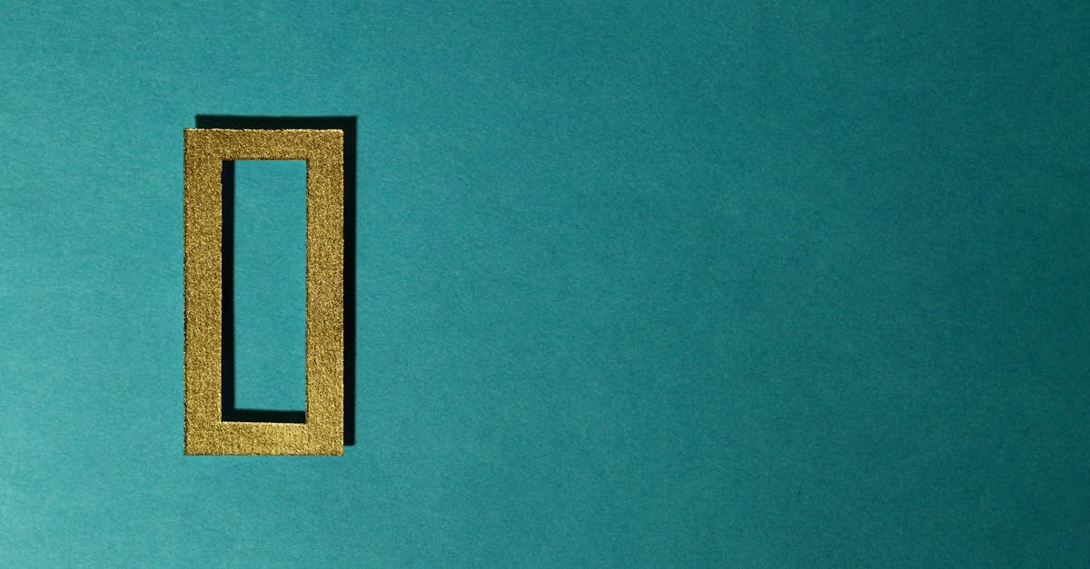 A gold rectangular frame casting a shadow on a teal background, minimal and artistic.