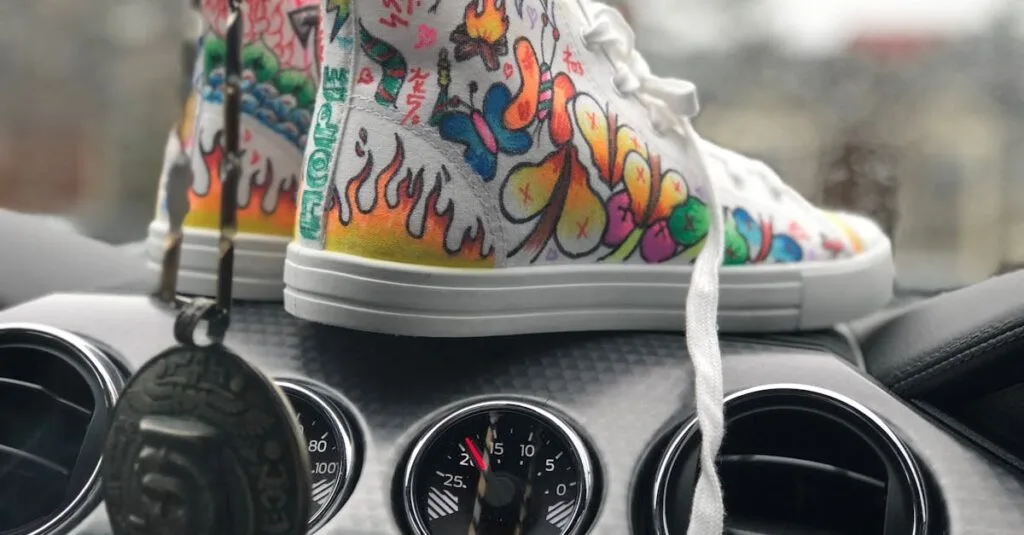 Vibrant graffiti sneakers displayed on a car dashboard, showcasing urban art style.