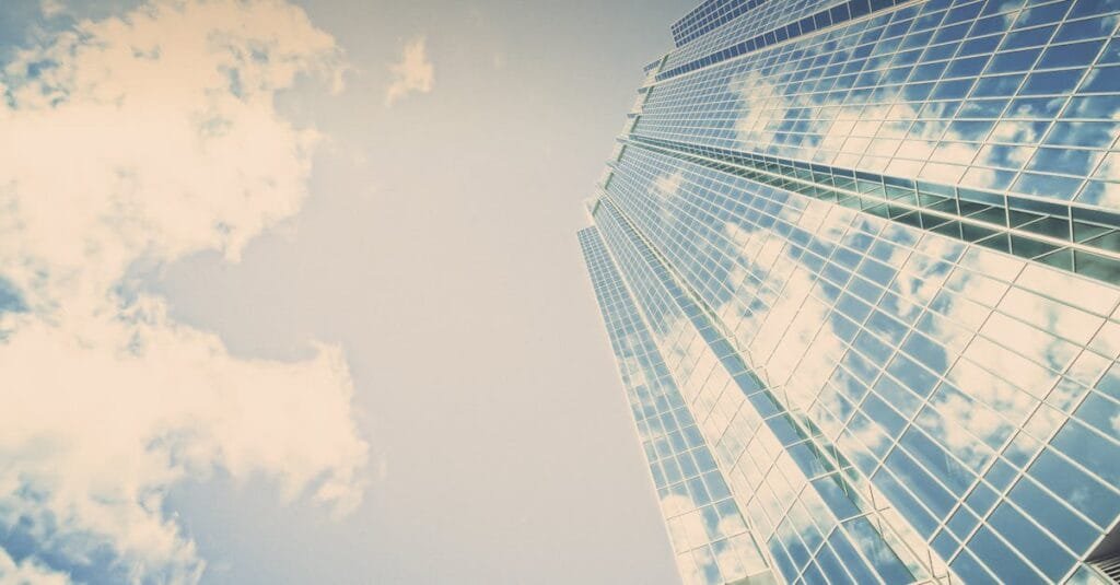A stunning skyscraper in London, Ontario reflecting clouds on its glass facade.