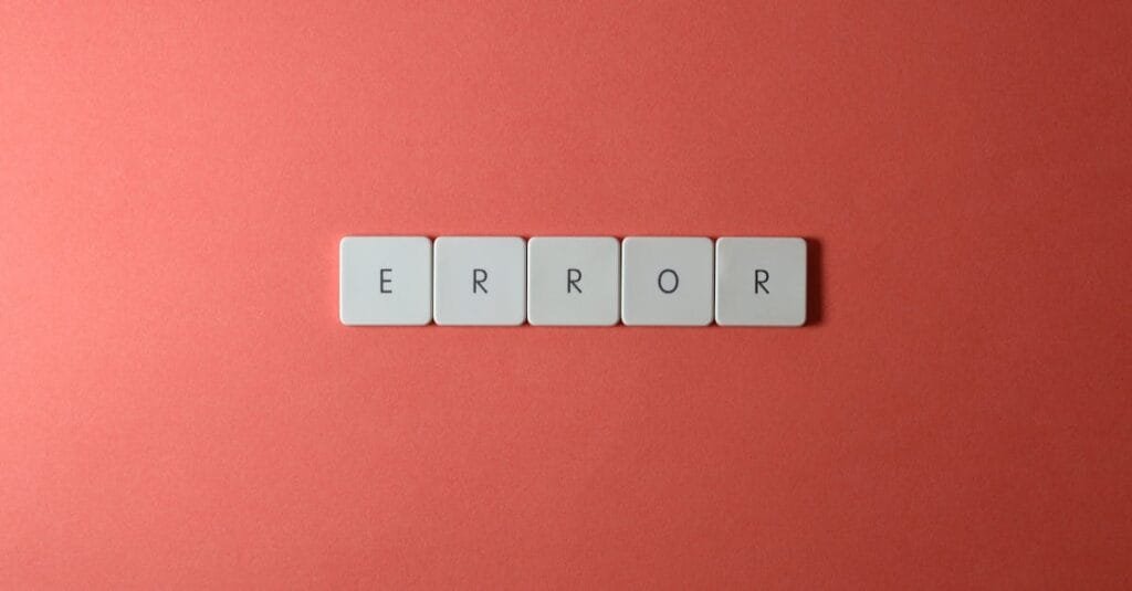 White letter tiles spelling 'ERROR' on a red backdrop, offering a minimalist design concept.