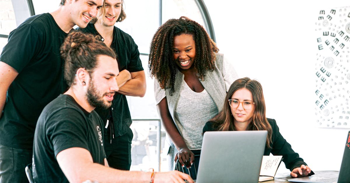Dynamic team of young adults collaborating on project in bright modern office environment.