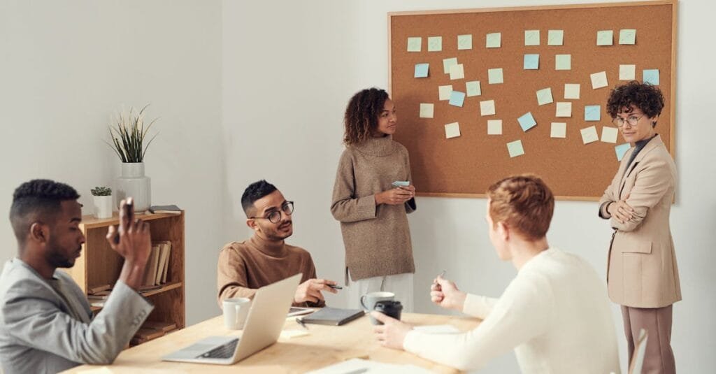A diverse group of professionals collaborating in a modern office setting with a brainstorming session.