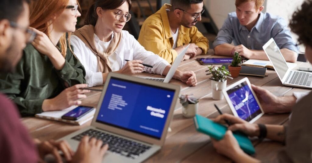 A diverse group of professionals having a collaborative meeting in a modern office setting.