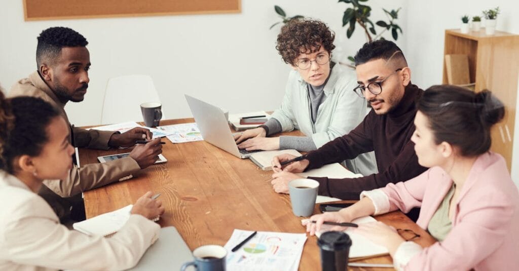 A diverse group of professionals engaged in a collaborative team meeting at the workplace.