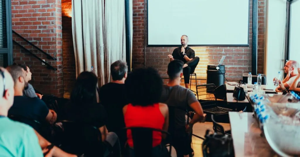 A dynamic seminar with a speaker engaging a diverse audience in a modern indoor setting.
