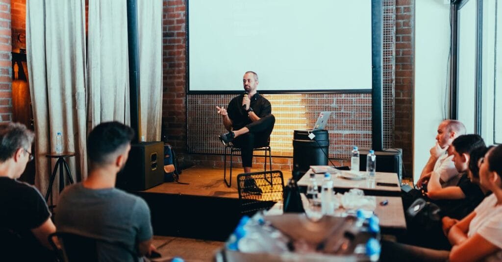 A business seminar with a speaker addressing an attentive audience in a modern conference setting.