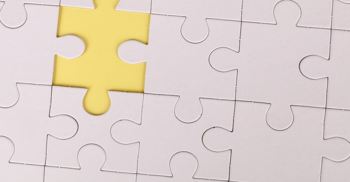 Close-up of a white jigsaw puzzle with a single yellow piece missing, symbolizing incompleteness.