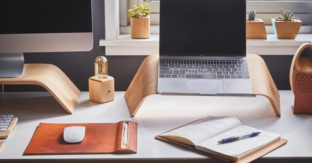 A stylish and contemporary home office setup with laptop and desk accessories.