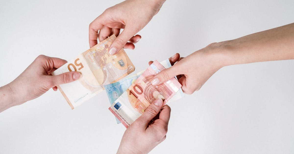 Two pairs of hands exchanging Euro banknotes, symbolizing finance and transaction.