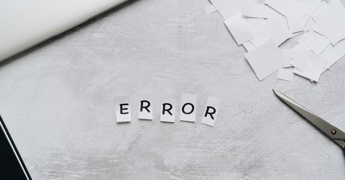Creative concept showing the word 'error' with cut out letters on a table with scissors and paper.