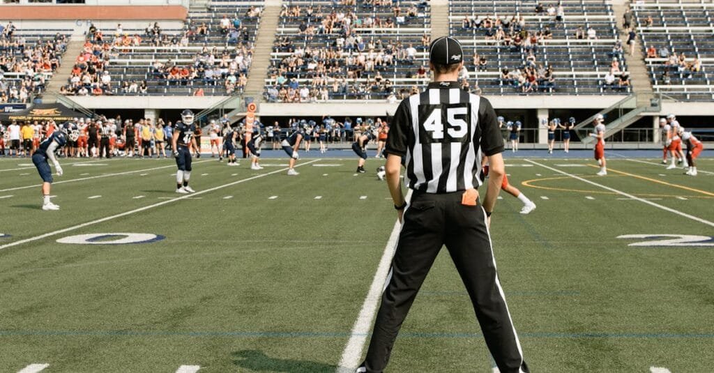American football game with referee and players in action at a stadium in Toronto, Canada.