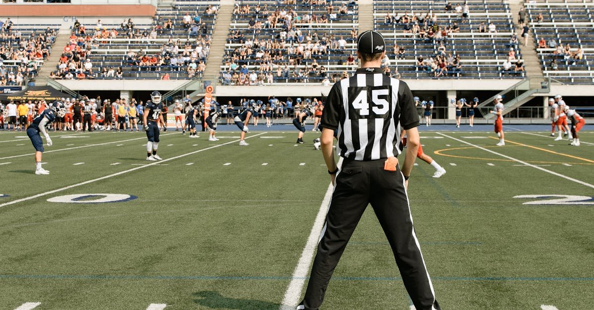 American football game with referee and players in action at a stadium in Toronto, Canada.