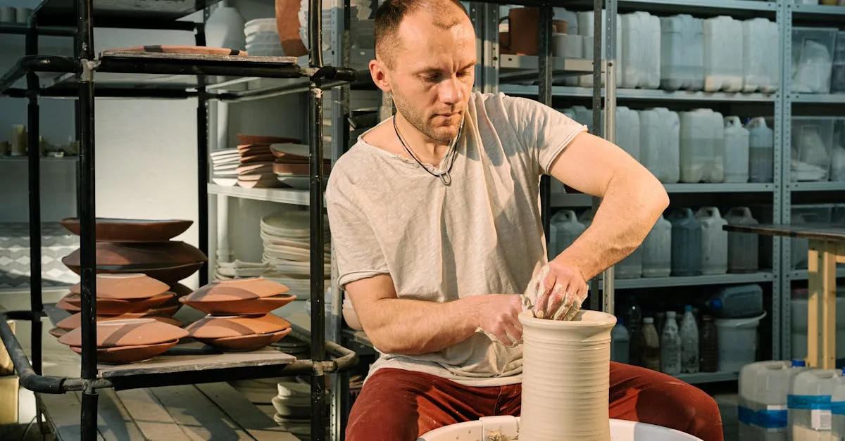 A male artisan focuses on crafting a clay pot using traditional pottery techniques.