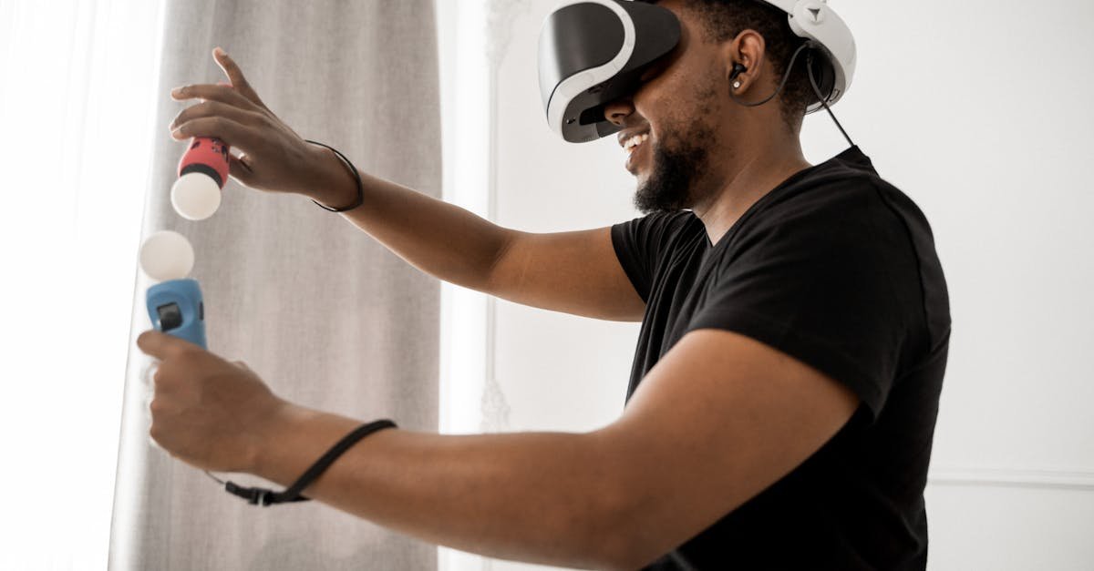 An adult man participates in a virtual reality simulation using VR glasses and controllers indoors.